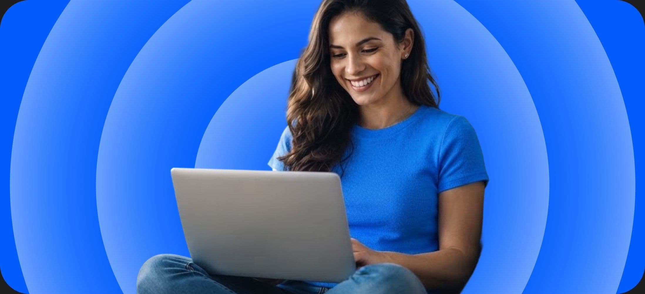 A woman sitting cross-legged working on a laptop